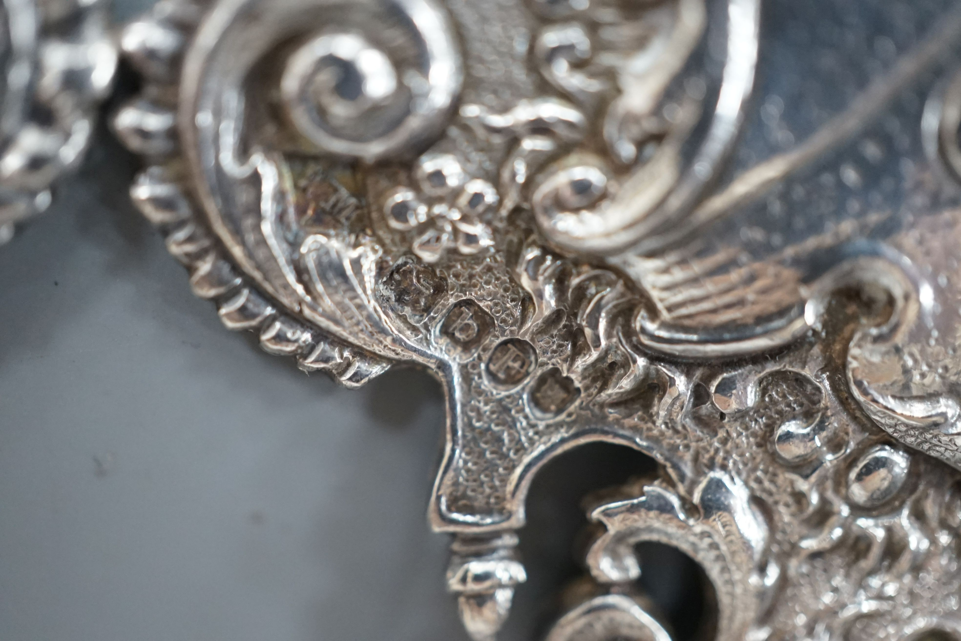 An 18th century Continental white metal belt buckle, modelled with the arms of the House of Bourbon and the Order of the Golden Fleece, height 7.5cm width overall 12cm, weight 66 grams